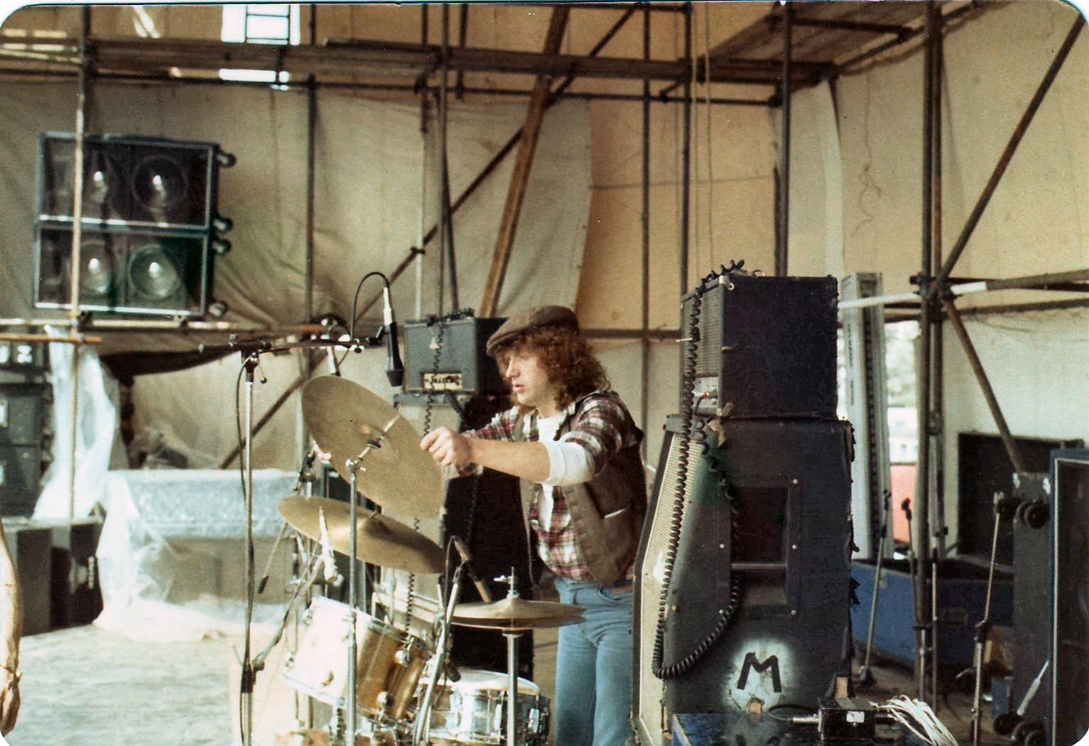 British blues guitarist Mick Clarke - Alan Platt setting up drums - SALT at Reading Rock 1977